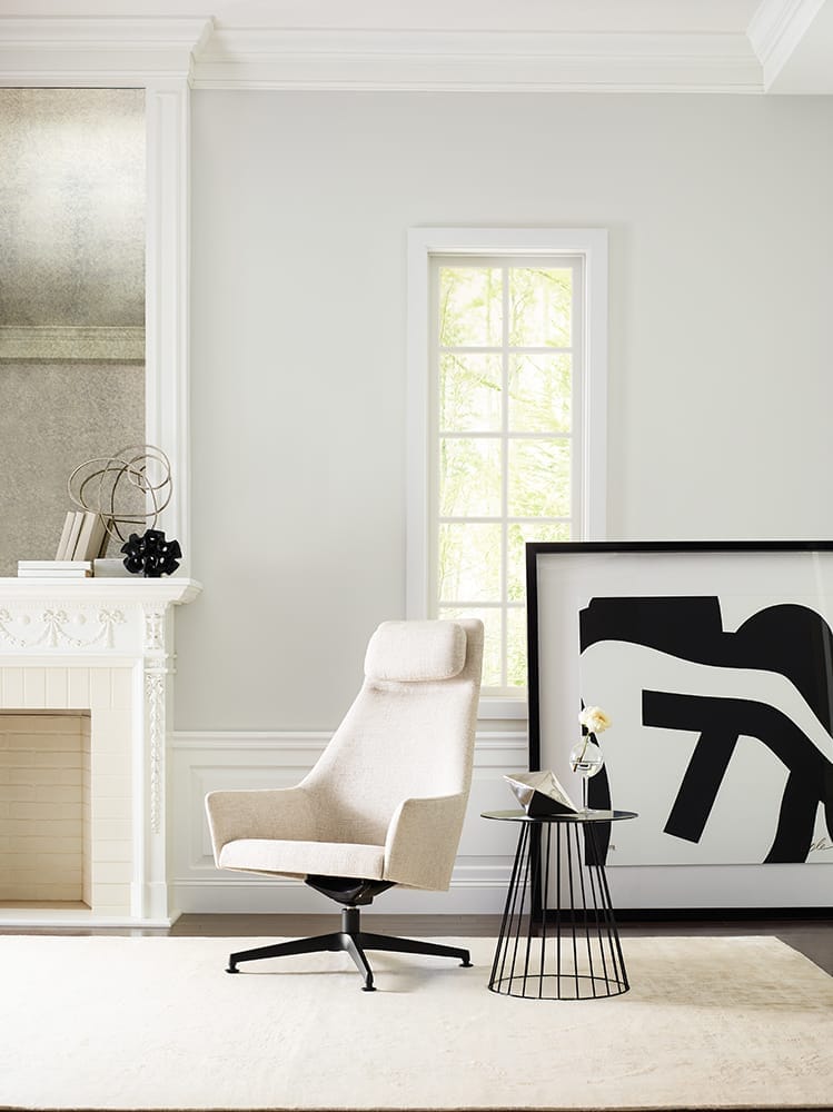 modern living room with accent chair, large scale artwork and cream walls