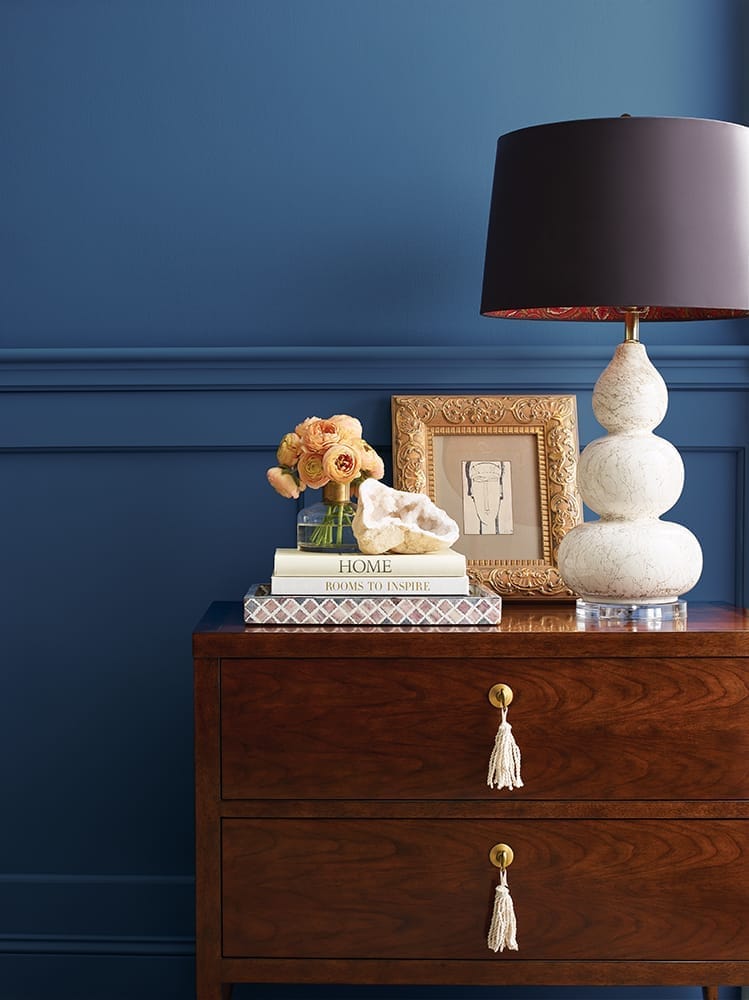 close up of tabletop accessories against an inviting blue wall with chair rail detail