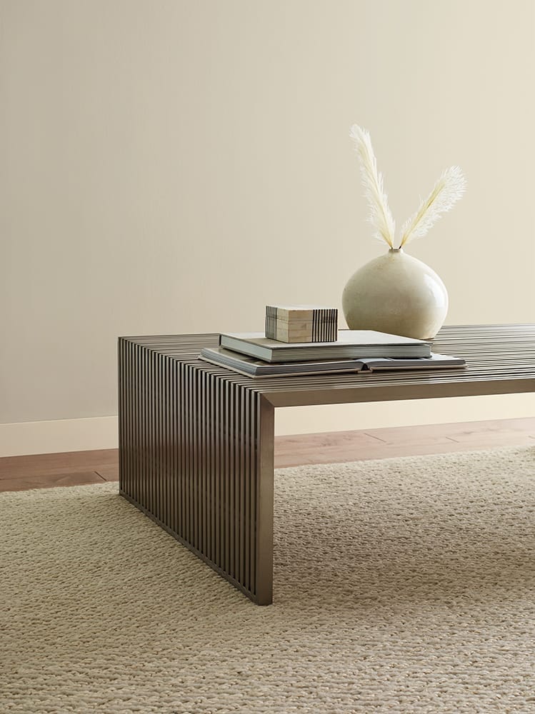 coffee table with accessories against tan wall