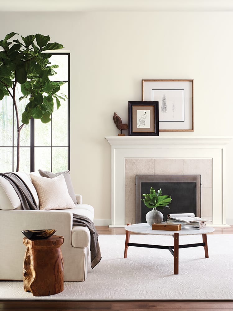 inviting casual living in soft cream and beige with fireplace, artwork and plants